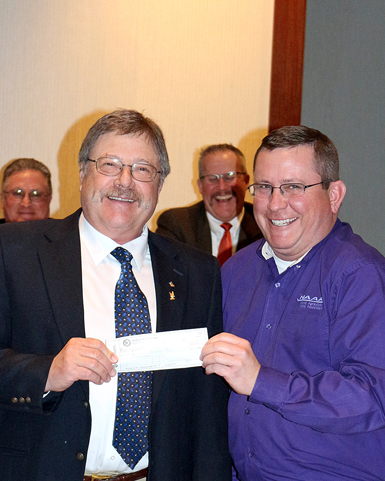 Bob Bailey, right, presents a $3,000 donation from the New Mexico AAA to NAAREF President Rod Thomas.